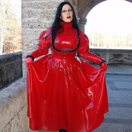 Dark Haired Fetish Lady Angelina In A Long Red Rubber Dress Poses In Public