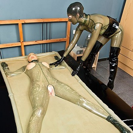 Two Fetish Lesbians Dressed In Transparent Rubber Clothes And Boots