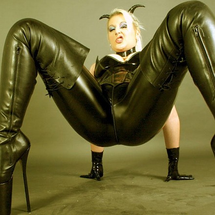 Blonde In Black Latex And Thighhigh Leather Boots